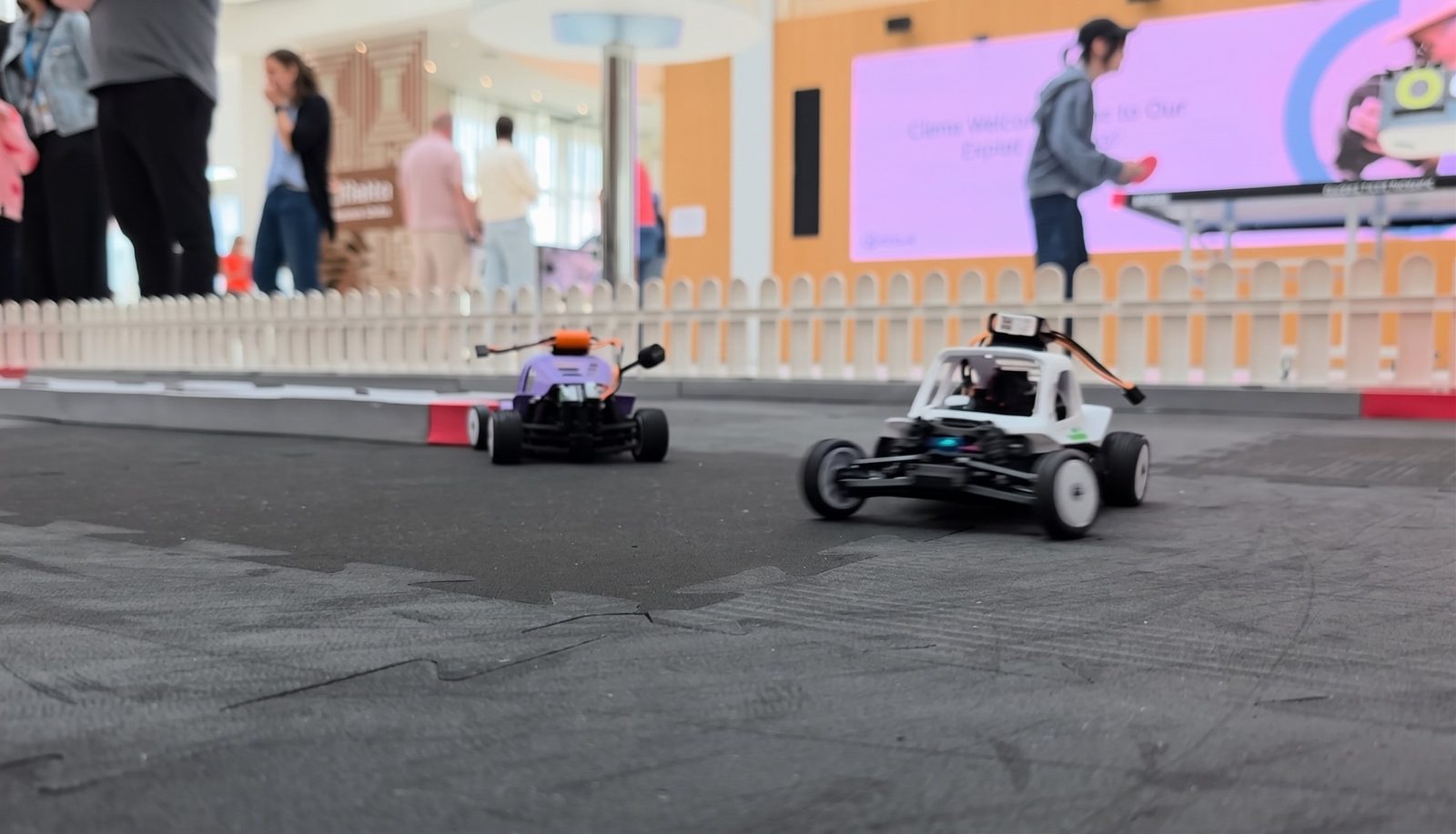 Two FPV RC cars with onboard cameras racing on the modular track