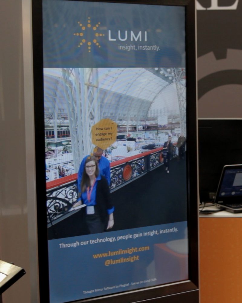 A thought mirror screen showing a guest on a show floor with a thought bubble above her head